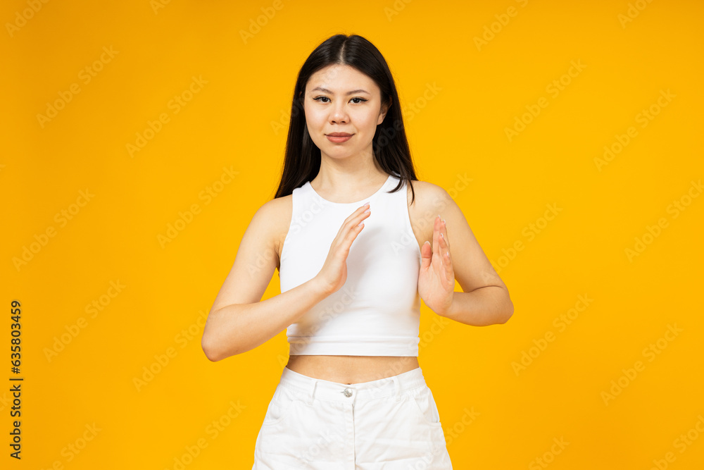 A girl of Asian appearance points with her hands to the chest area. A girl of Asian appearance points with her hands to the chest area.