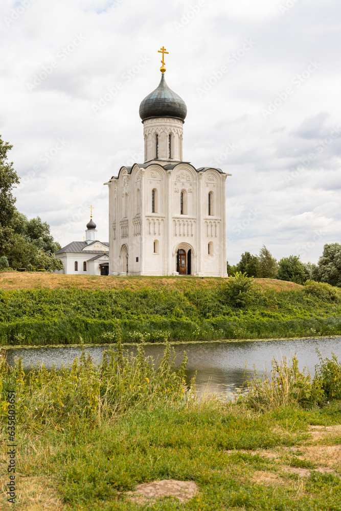Christian church standing on a hill across the river