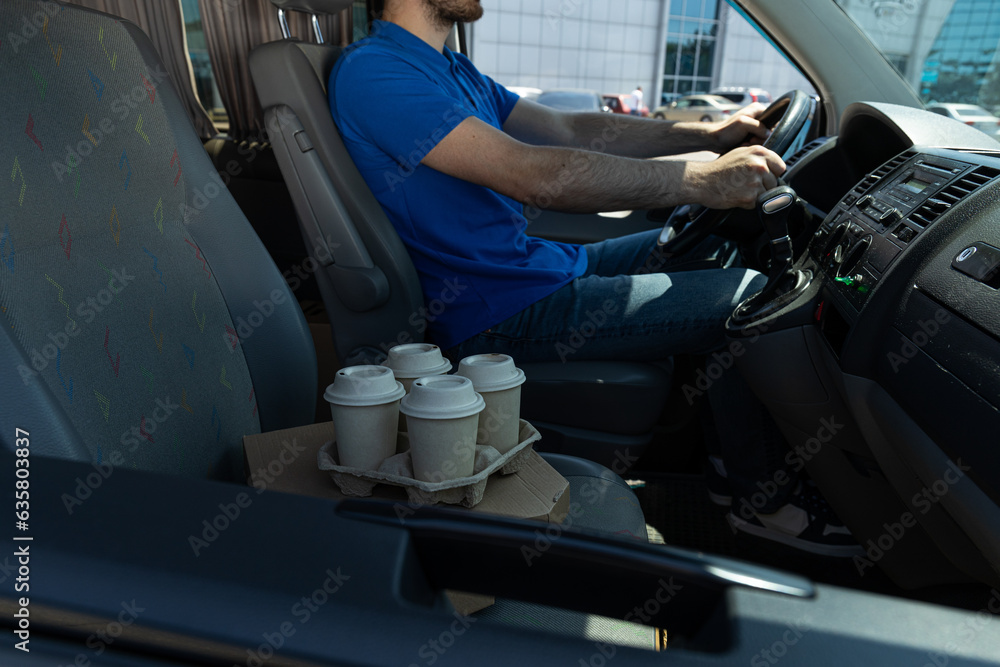 The courier delivers coffee and pizza by car The courier delivers coffee and pizza by car
