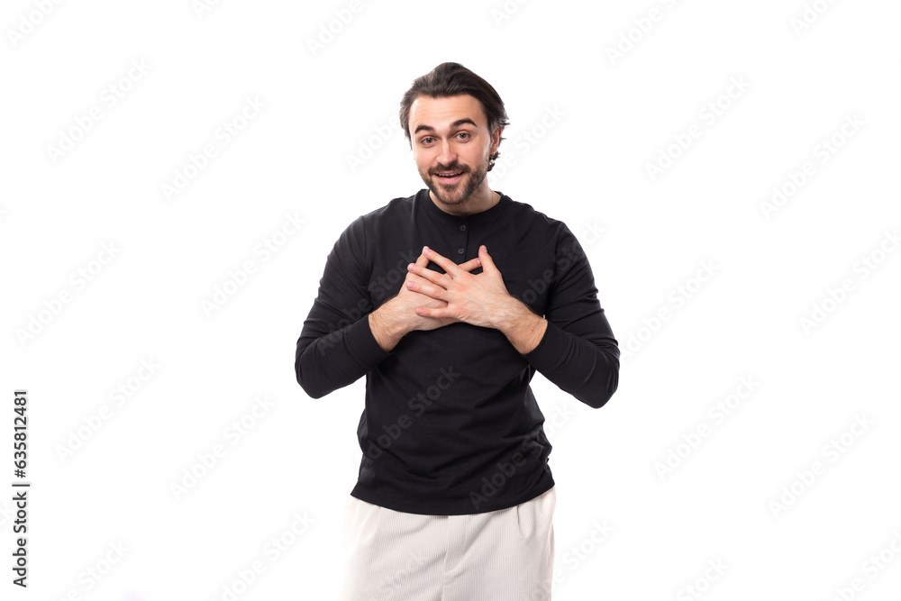 portrait of a smart young 30s authentic brunette male adult with a beard in a black sweater on a white background with copy space portrait of a smart young 30s authentic brunette male adult with a beard in a black sweater on a white background with copy space