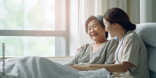 The old patient is sick and hospitalized, the young Asian woman visits the elderly woman.