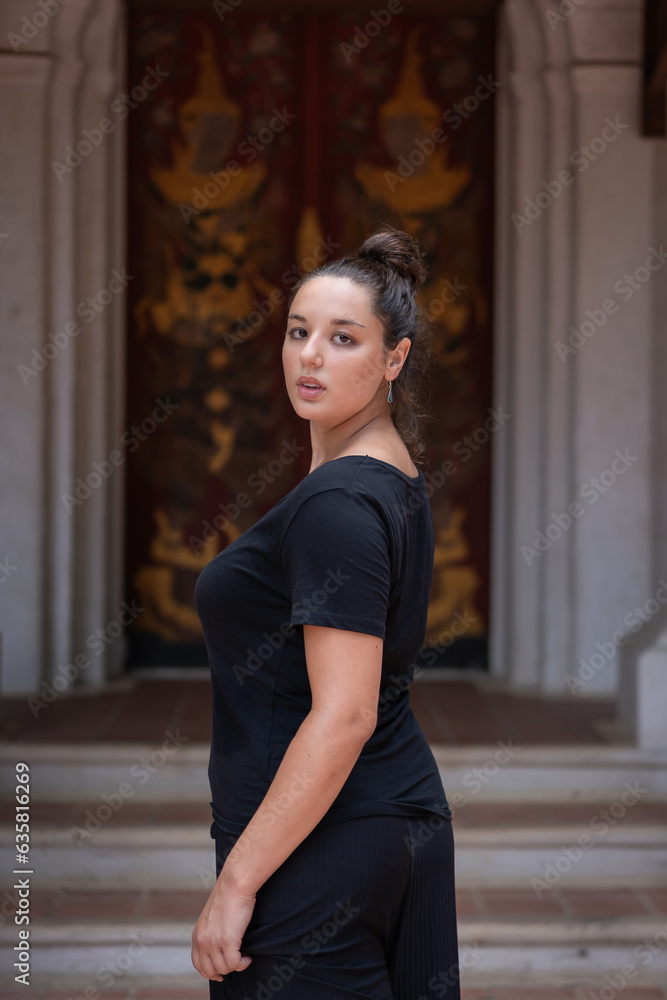 Beautiful Caucasian tourists wearing casual dressed modern black casual clothes post at Wat Pha Lat Temple. Which is an ancient temple in Chiang Mai, Thailand.
