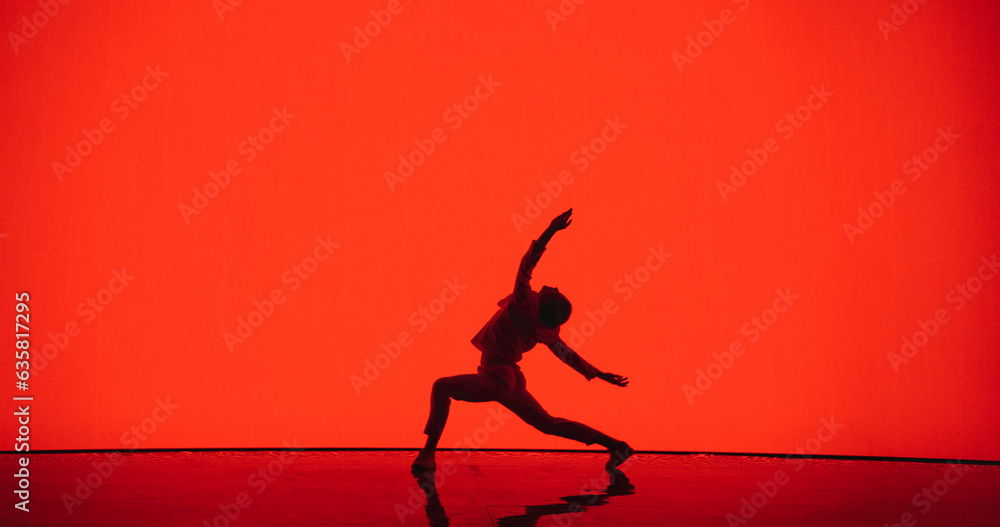 Male Dancer in White Clothes Unleashing an Energetic Fusion of Styles with Powerful Modern Dance Choreography, Swift Turns and Athletic Grace, Dancing in Front of an Solid Red Digital Screen