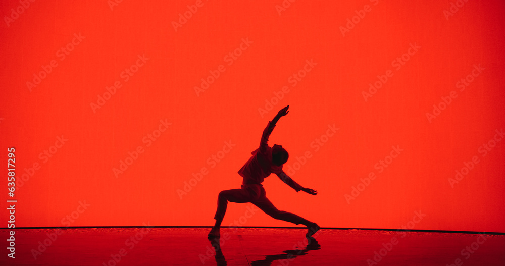 Male Dancer in White Clothes Unleashing an Energetic Fusion of Styles with Powerful Modern Dance Choreography, Swift Turns and Athletic Grace, Dancing in Front of an Solid Red Digital Screen Male Dancer in White Clothes Unleashing an Energetic Fusion of Styles with Powerful Modern Dance Choreography, Swift Turns and Athletic Grace, Dancing in Front of an Solid Red Digital Screen