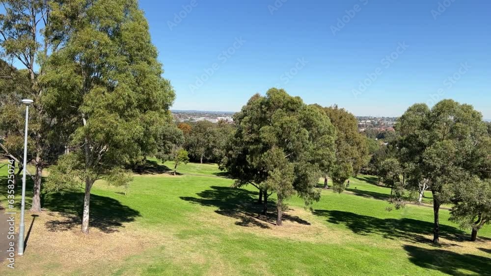 180 degree view of a Suburban western Sydney Park in NSW Australia trees walking trails and kids playground and houses in the horizon 180 degree view of a Suburban western Sydney Park in NSW Australia trees walking trails and kids playground and houses in the horizon