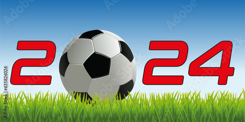 L’année 2024 avec un ballon de football posé sur la pelouse d’un terrain pour symboliser le lancement de la nouvelle saison de compétition.