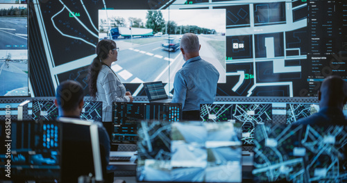Diverse Team of Specialists Analyze Surveillance Feeds, Monitor Targets on a GPS City Map, Ensure Efficient Traffic Operations. Intensive Work in a Monitoring Room with Big Data Analytics Engineers