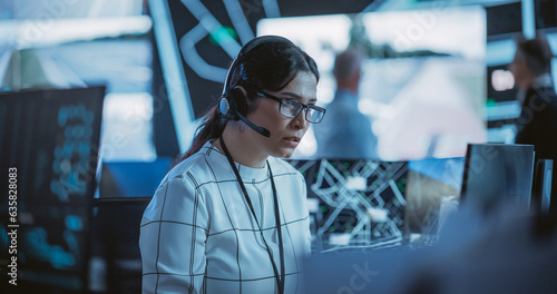 Portrait of a Female Fleet Operator Working in an Office Hub for Order Delivery, Control and Client Support. Logistics Manager Wearing a Headset, Having a Conversation with Team Leader