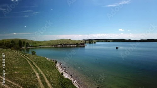Wallpaper Mural Aerial Backward Over Lake Near Green Hills Against Blue Sky On Sunny Day - Billings, Montana Torontodigital.ca