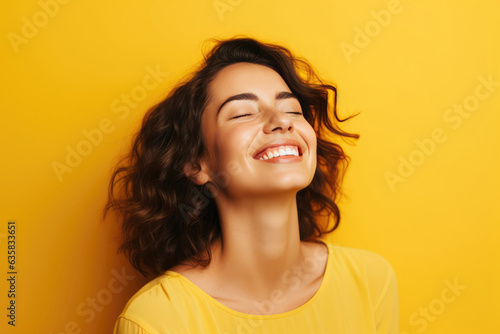 Beautiful Young Happy European Woman On Yellow Background