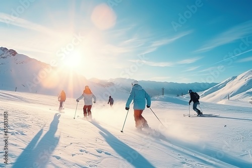 Team winter sports skiers and snowboarders with sunlight. Travel ski resort with group of friends, young people skiing on mountain top in winter