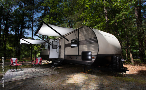 White awnings out on an RV in a campsite © Guy Sagi