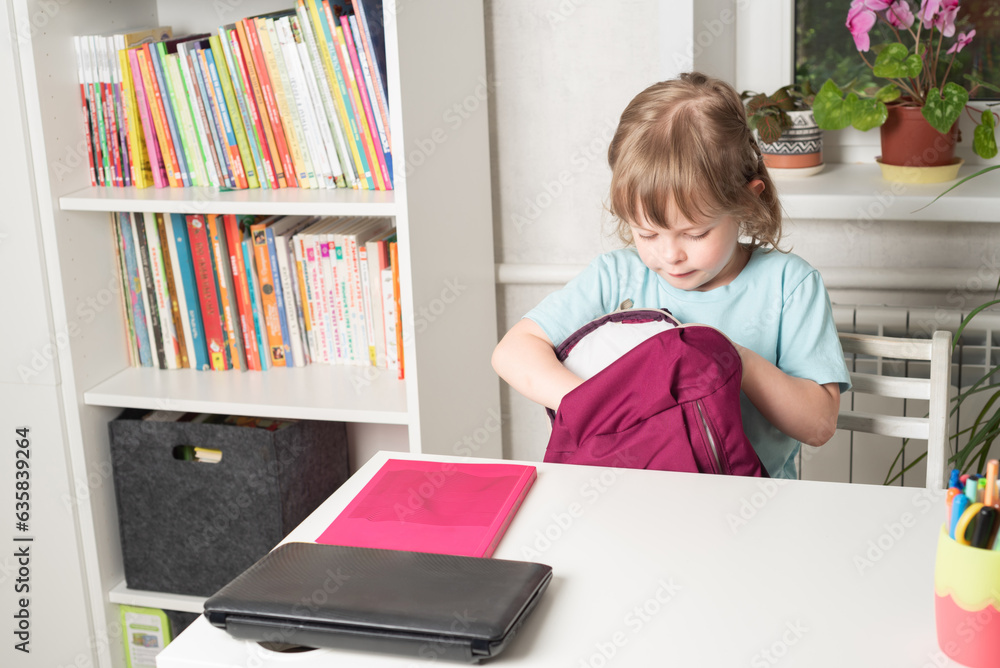Girl takes out books and stationery from her backpack. Preparation for school. Back to school. Girl takes out books and stationery from her backpack. Preparation for school. Back to school.