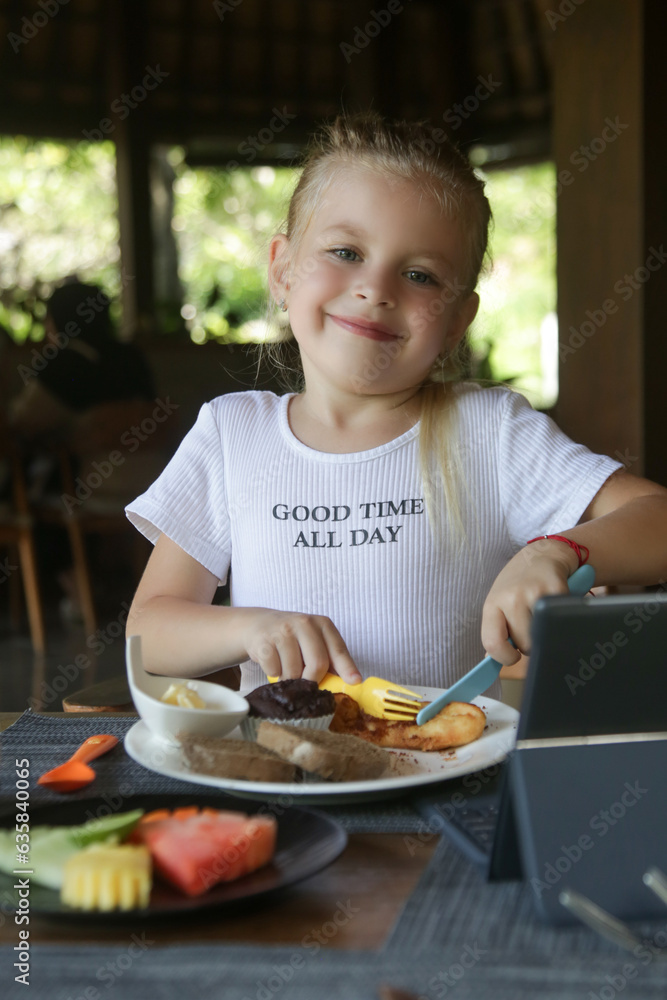 Cute 5 years old girl having kids meal at the restaurant Cute 5 years old girl having kids meal at the restaurant