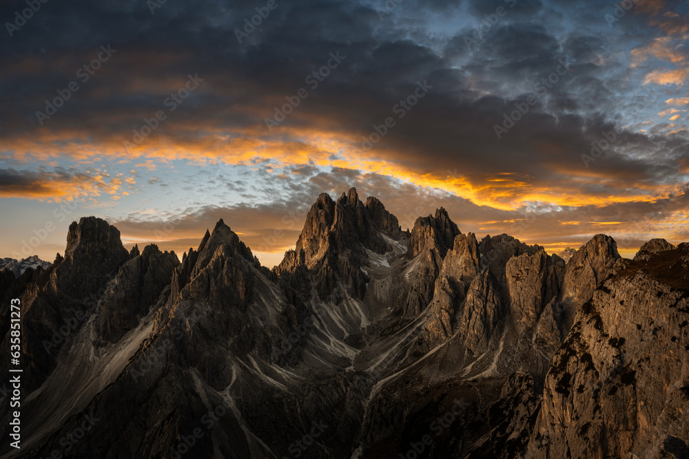 Marmarole mountain group with Cimon del Froppa against the backdrop of incredible orange sunset sky, Dolomites, Italy. Landscape photography