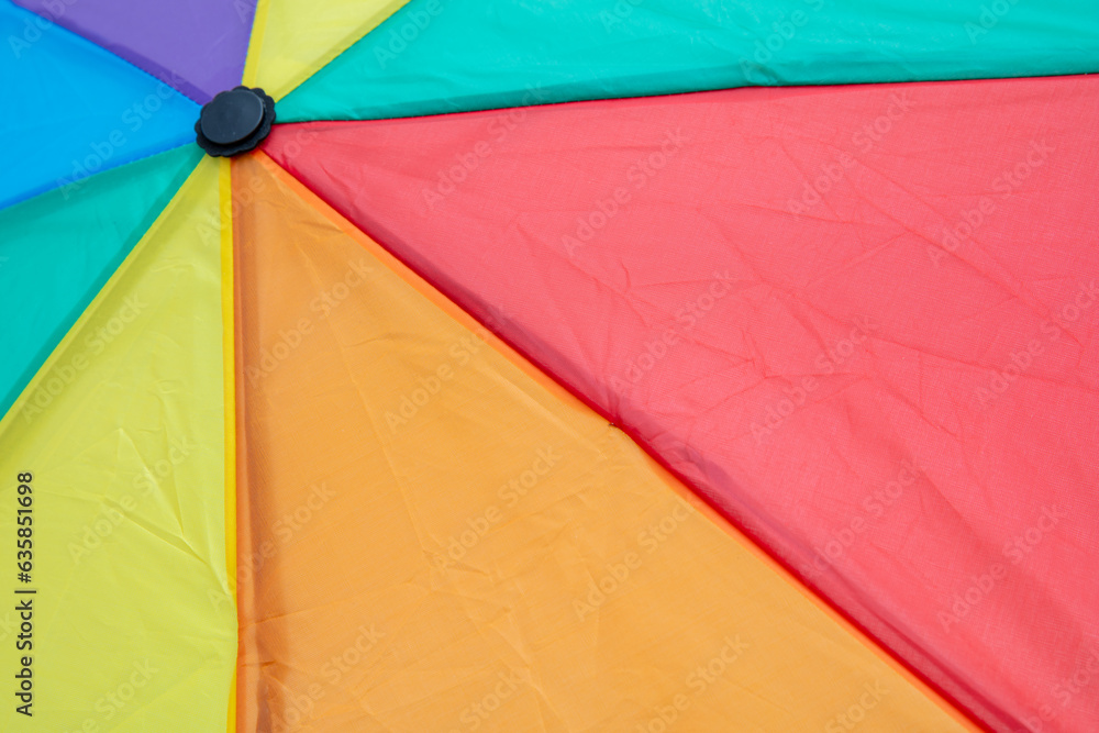 Rainbow colors umbrella closeup, vibrant display of colors background