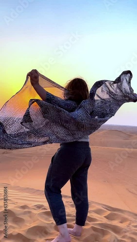 Beautiful woman in the desert during sunset. High quality FullHD footage photo