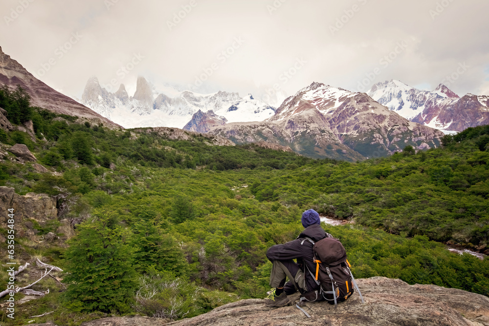 Fototapeta premium Beautiful nature of Patagonia. Man with a backpack observing the view at Fitz Roy trek, view of Andes mountains, Los Glaciers National Park, El Chalten, Argentina