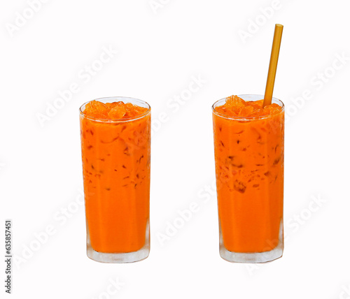  Iced milk tea color orange with crushed ice in glass on tall square shape fragrant sweet with straw isolated on white background. Refreshing drink in tropical. Old-fashioned tea, popular in Thailand.