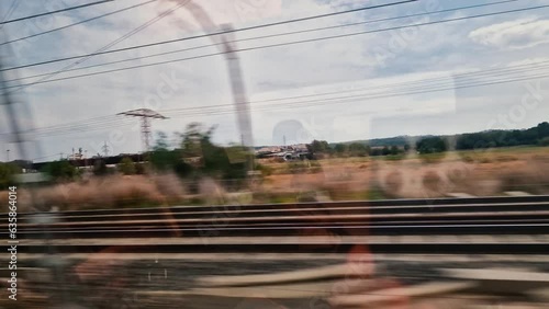 Landscape at speed From a train window in Spain. Fields and buildings with reflection in the glass of the wagon