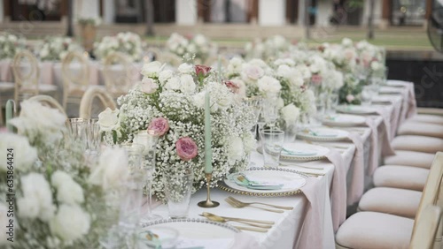 Event party reception decor outdoor. Wedding set up bouquet flowers candle tablecloth catering dinner.