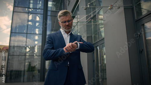 Foto Relaxed middle-aged man senior mature business employer businessman walking in c