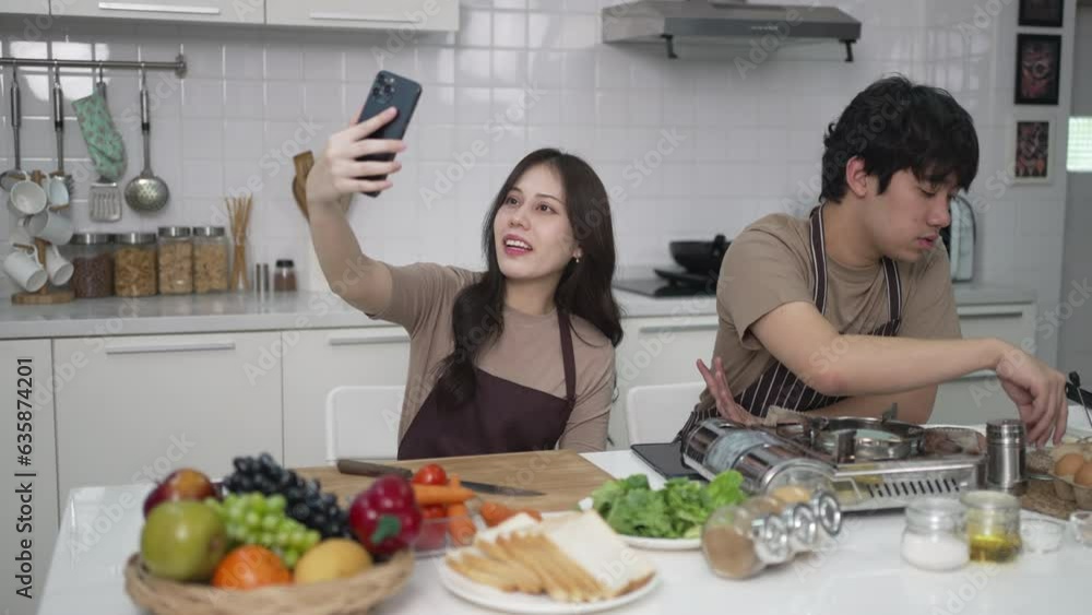 Young couple is livestreaming in kitchen. Young couple is livestreaming in kitchen.