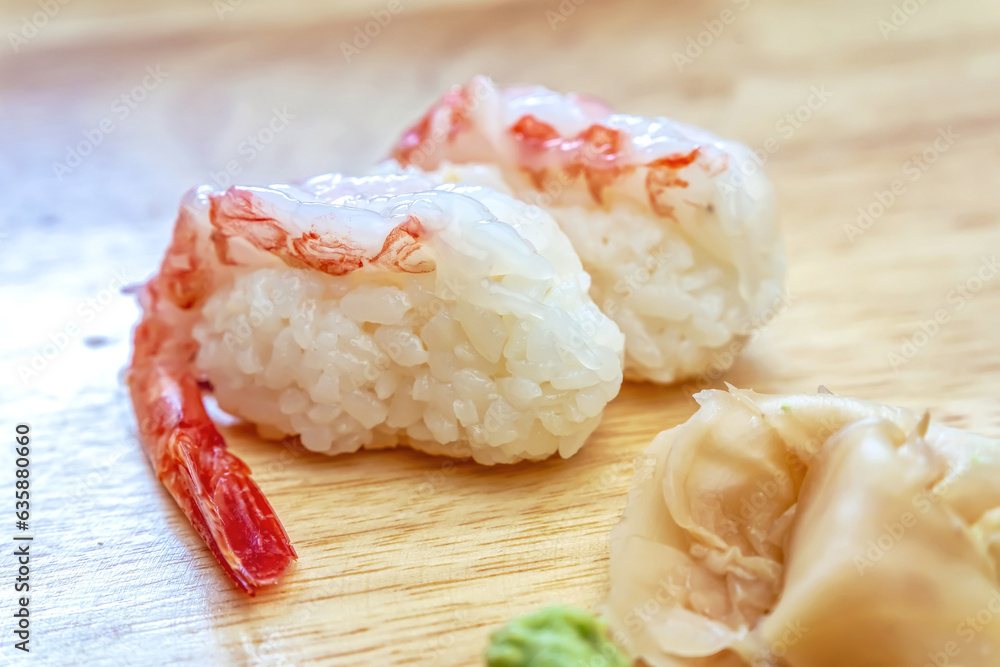 Sashimi sushi on the wood table. Sushi is a type of food preparation originating in Japan. Sashimi sushi on the wood table. Sushi is a type of food preparation originating in Japan.