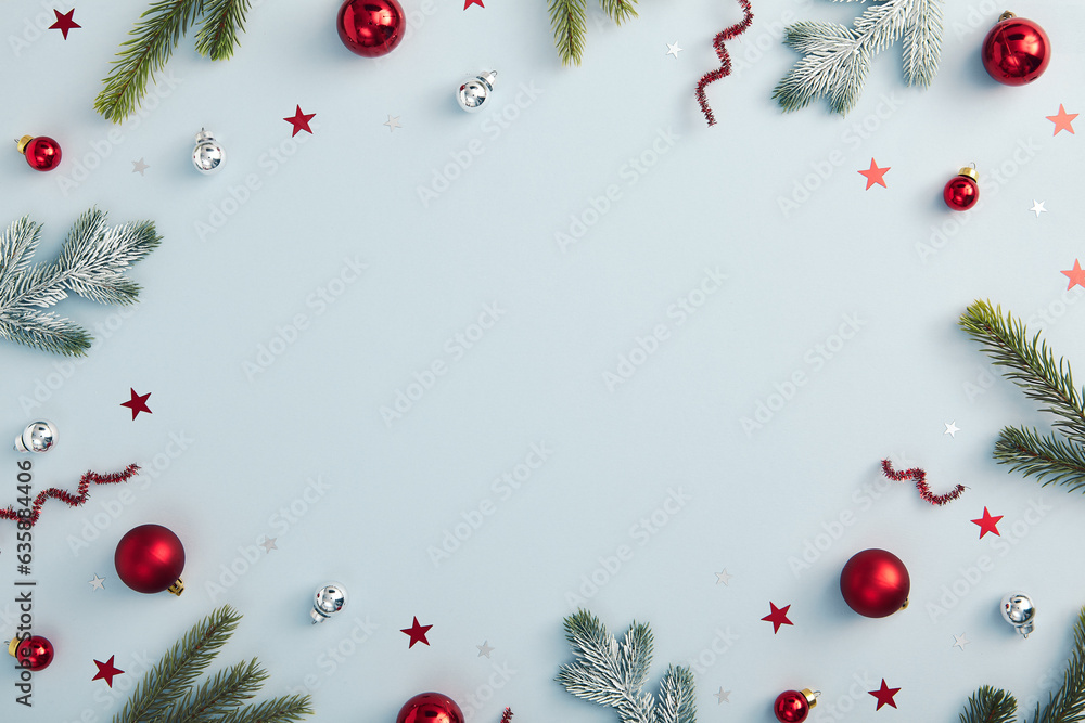 Christmas flat lay with festive ornaments, pine branches on a pastel blue background. Ideal for holiday greetings and celebration cards Christmas flat lay with festive ornaments, pine branches on a pastel blue background. Ideal for holiday greetings and celebration cards
