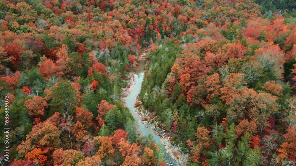 Aerial drone flying over Arkansas ozark mountains and blue river in autumn with fall colored forest leaves Aerial drone flying over Arkansas ozark mountains and blue river in autumn with fall colored forest leaves