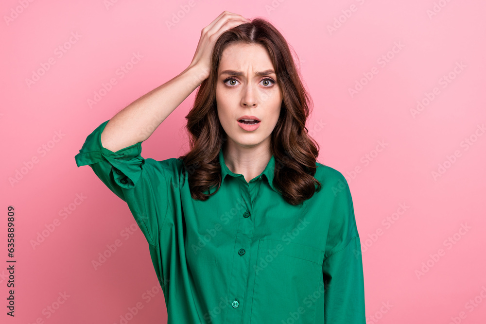 Photo of unhappy shocked woman dressed green shirt arm head open mouth isolated pink color background Photo of unhappy shocked woman dressed green shirt arm head open mouth isolated pink color background