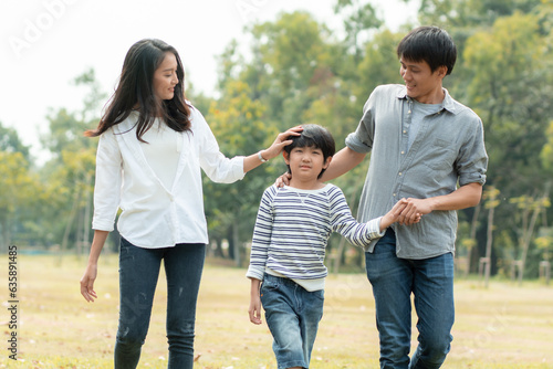 Happy Asian family spending time together outside in green nature and park, vacation of parents concept.