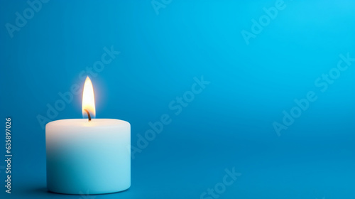 burning candle on blue background