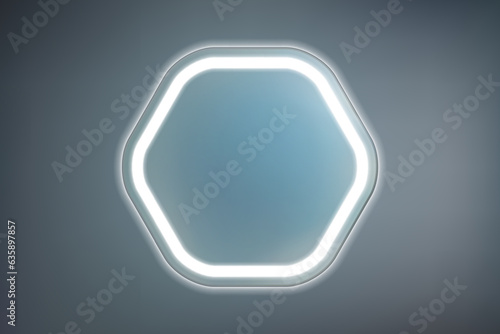 Hexagonal mirror with rounded corners with built-in white LED light on a dark wall. Contemporary bathroom lighting