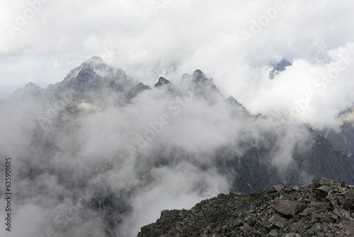 Ladovy stit and Prostredny hrot, view from Slavkovsky stit, High Tatras, Vysoke Tatry, Slovakia. Misty and foggy rocky mountains. Top, peak and summit are covered by mist and fog. photo