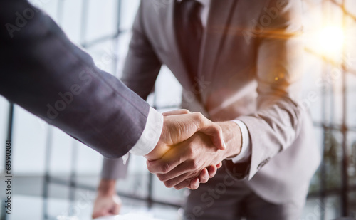 Tableau sur toile Handshake of two businessmen who enters into the contract to develop a new software to improve business service at a company