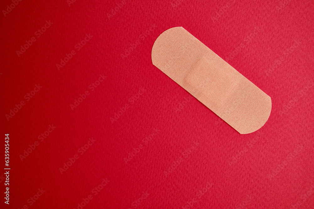 Medical plaster on a red background. Blood donation, space for text. Health and medicine concept
Medical plaster on a red background. Blood donation, space for text. Health and medicine concept
