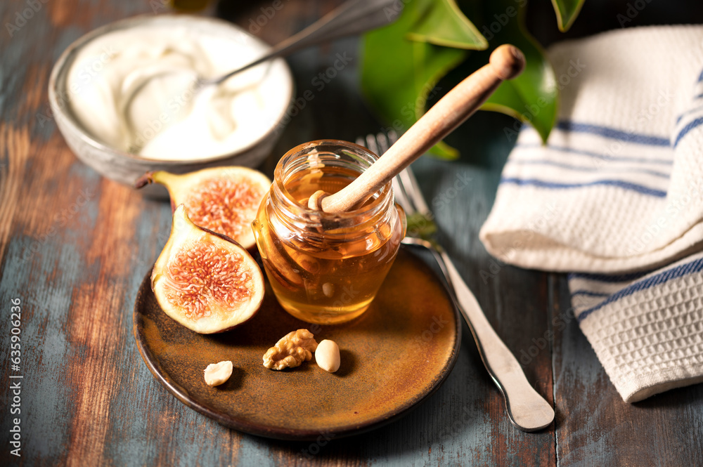 Delicious Greek honey from Rhodes with figs and bowl of yogurt Delicious Greek honey from Rhodes with figs and bowl of yogurt