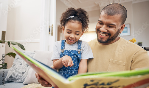 Dad, daughter and book on sofa together, bonding and love in storytelling in living room with smile. Happiness, father and child reading story on couch for fantasy, learning and education in home fun