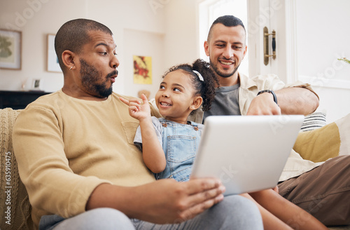 Tablet, gay family and child on home sofa for e learning, watch video and education on internet. Adoption, lgbt men or parents with a happy kid and technology for streaming movies, games or app