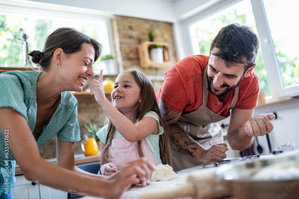 Family makes a cookie in the kitchen Family makes a cookie in the kitchen
