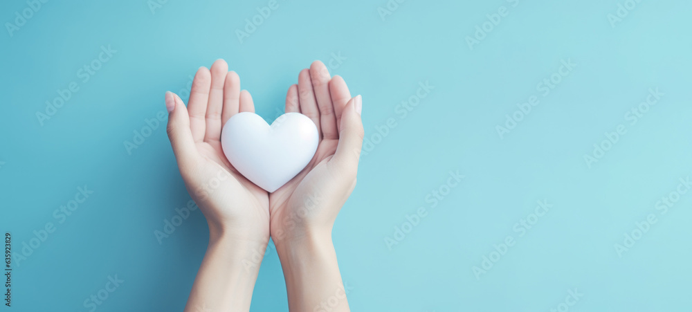 Fototapeta premium Hand holding white heart, World health day, Health care and mental health concept, Health insurance, Charity volunteer donation, CSR responsibility, World heart day, Self love