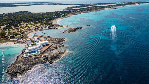 Aerial of the turquoise waters and white sand beach of the Pujols beach, Formentera, Balearic Islands, Spain, Mediterranean