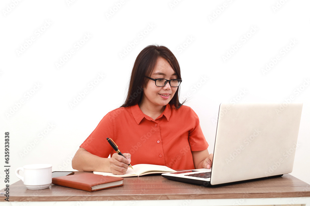 Excited young asian entrepreneur woman writing something while learning something from online course Excited young asian entrepreneur woman writing something while learning something from online course