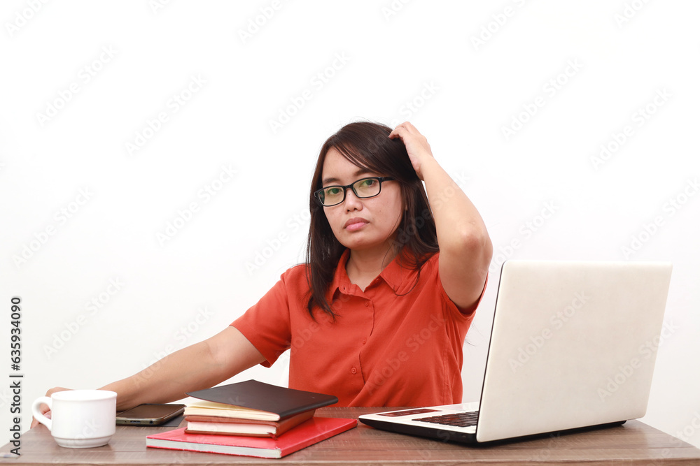 Confused young asian entrepreneur woman sitting while holding her head. Isolated on white Confused young asian entrepreneur woman sitting while holding her head. Isolated on white