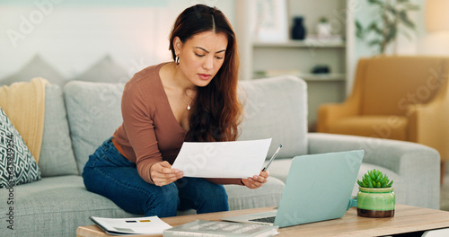 Woman, paper and laptop in living room on sofa working on project, assignment or task for college or business. Student, girl and home to study, for test or exam at university with handheld movement