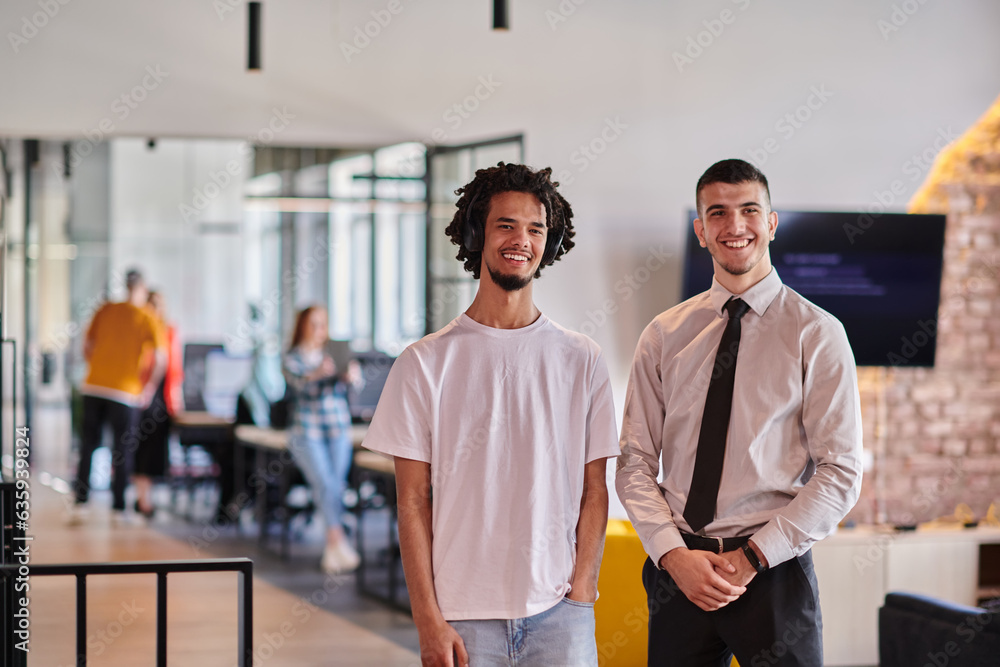 A group of colleagues, including an African American businessman and a young leader in a shirt and tie, pose together in a modern coworking center office, representing a dynamic blend of A group of colleagues, including an African American businessman and a young leader in a shirt and tie, pose together in a modern coworking center office, representing a dynamic blend of