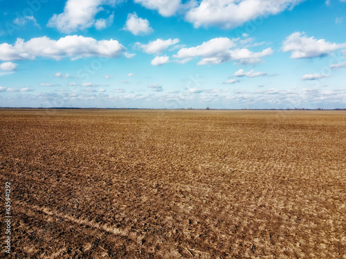 Beautiful blue sky over farm fields on a sunny day, aerial view. Landscape.