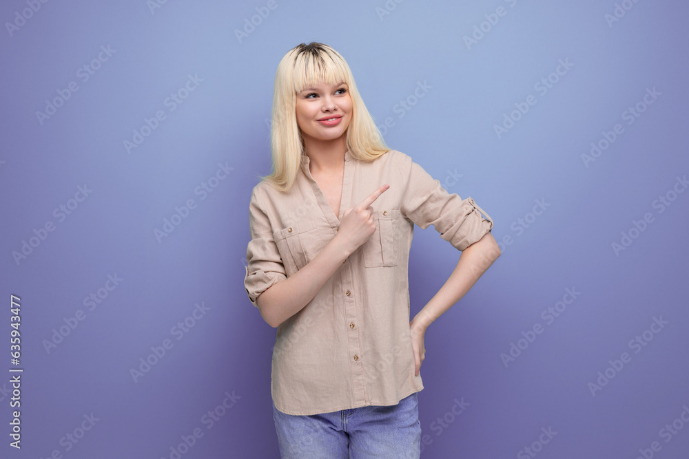 surprised energetic blond young woman pointing a finger to the side telling some news surprised energetic blond young woman pointing a finger to the side telling some news