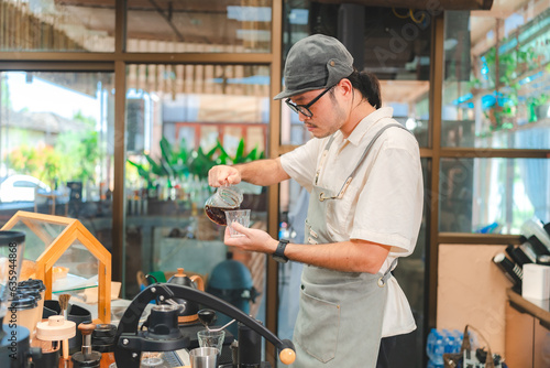 Barista at a coffee shop pr...